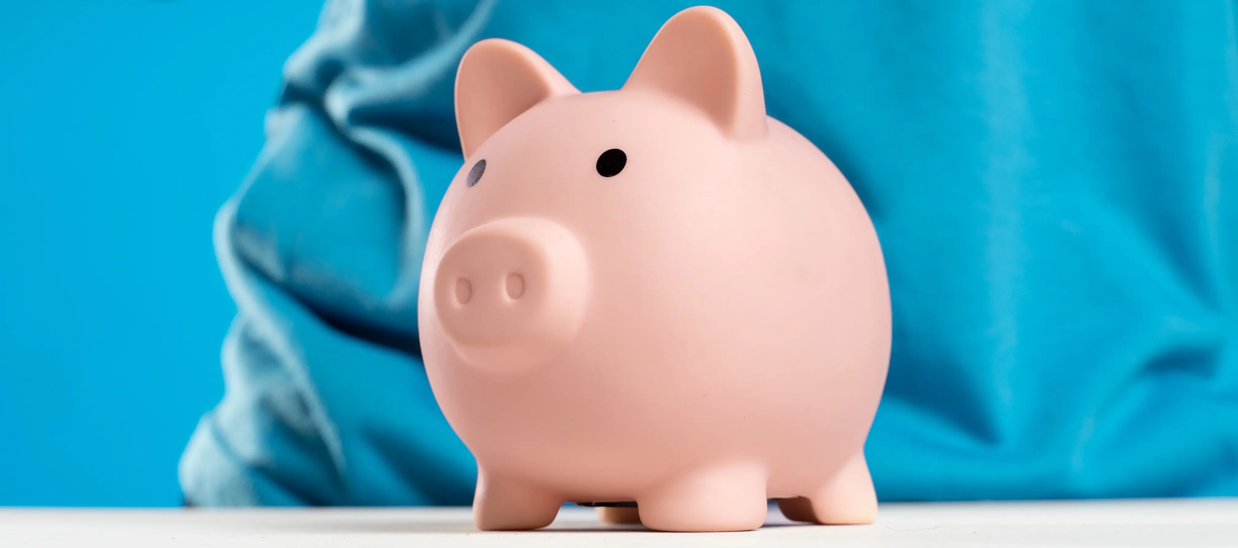 A white piggy bank on a blue background