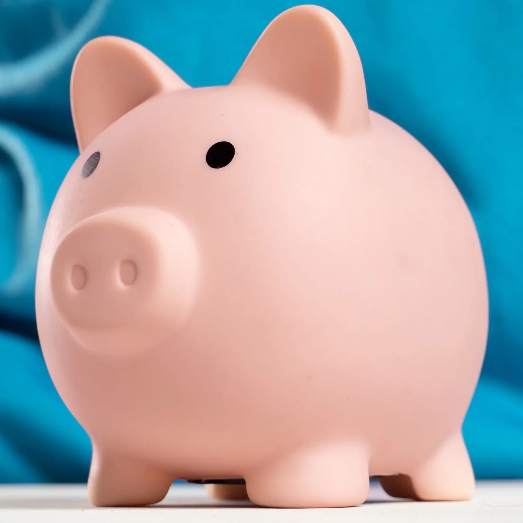 A white piggy bank on a blue background